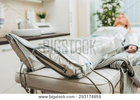 Selective Focus On Woman Lying On Beauty Couch During Pressotherapy Session