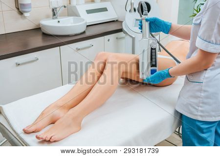 Cropped View Of Cosmetologist Doing Endospheres Therapy For Leg