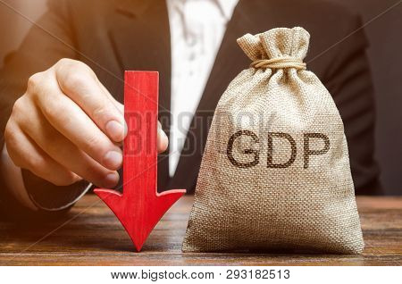 A Bag With The Word Gdp And A Down Arrow In The Hands Of A Businessman. Decline And Decrease Of Gdp 