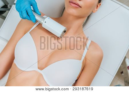 Partial View Of Cosmetologist In Rubber Gloves Doing Endospheres Therapy For Chest