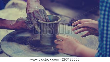 Making It Together. Close-up To Hands Of Potter Teacher And Child