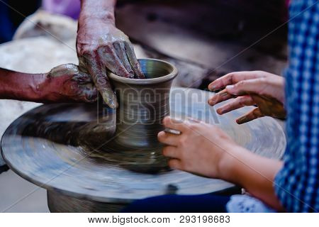 Making It Together. Close-up To Hands Of Potter Teacher And Child