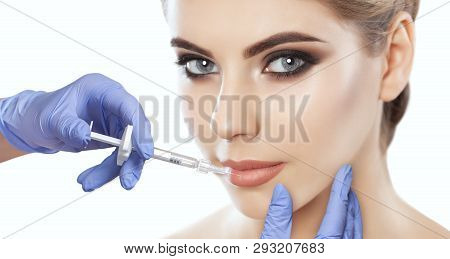 The Doctor Cosmetologist Makes Lip Augmentation Procedure Of A Beautiful Woman In A Beauty Salon.cos