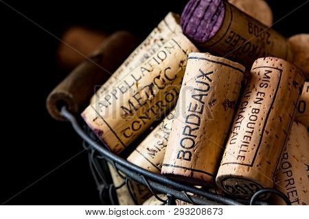 Old Cork Stoppers Of French Wines In A Wire Basket