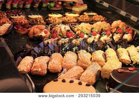 Bakery Products Desserts, Pastries, Cakes And Various Sweets At Cafeteria And Coffee Shop Window. Ma