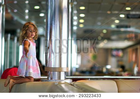 Three-year-old Girl Plays Happily In The Ferry Hall Connecting Igoumenitsa To Brindisi In Italy