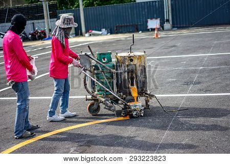 Workers Are Lining On The Asphalt Roat With Paint The Thermoplastic By Machine