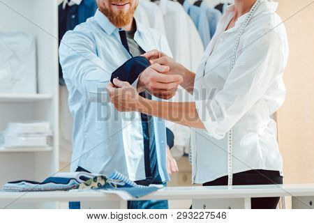 Man in fitting of a bespoke shirt in fashion studio of tailor