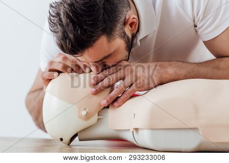 Man Using Mouth To Mouth Technique On Dummy During Cpr Training
