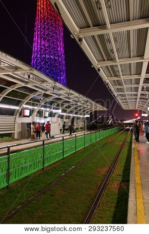 Guangzhou, China - Mart 9, 2019: Night Guangzhou City Tram Station Near Luminous Canton Tower During