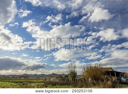 Village House On Field And Cloudy Sky Autumn Background