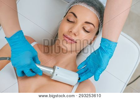 Partial View Of Cosmetologist In Rubber Gloves Doing Endospheres Therapy For Chest