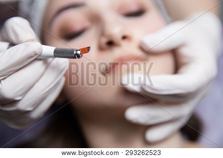 Permanent Makeup For Eyebrows. Microblading Brow. Beautician Doing Eyebrow Tattooing For Female Face