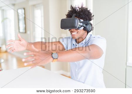 African amaerican man having fun playing with virtual reality glasses