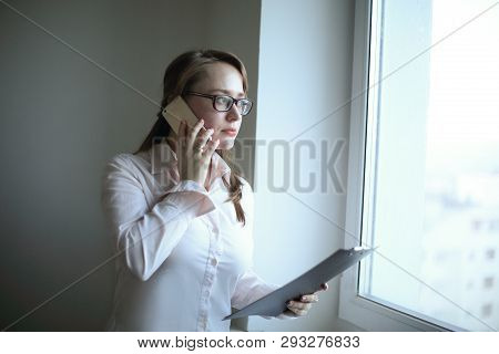 Business Woman Listens To The Interlocutor On The Phone.