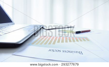 Calculator And A Marketing Scheme On The Table From A Businessm
