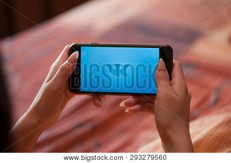 Saint-Petersburg / Russian Federation - 27 March 2019: Female hand with manicure holding cellphone with VK