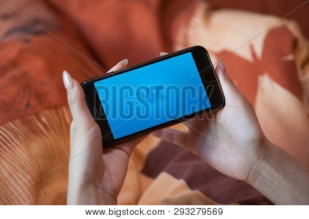 Saint-Petersburg / Russian Federation - 27 March 2019: Female hand with manicure holding cellphone with VK