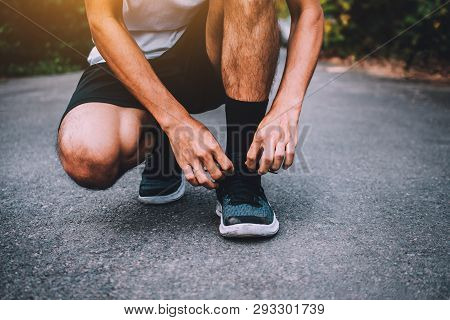 Runners Tied In Shoes,man Run On The Street Be Running For Exercise,run Sports Background And Closeu