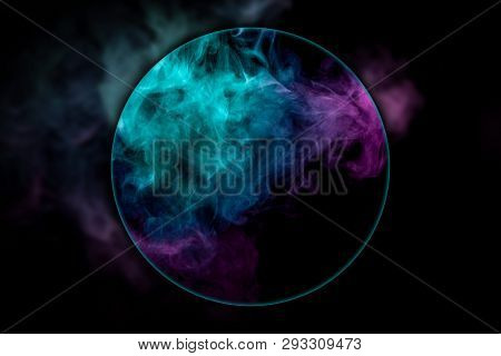 Close-up сloud Of Pink And Blue Smoke  Blown Under A Magnifying Glass On A Black Isolated Background