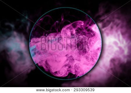 Close-up сloud Of Pink And Blue Smoke  Blown Under A Magnifying Glass On A Black Isolated Background