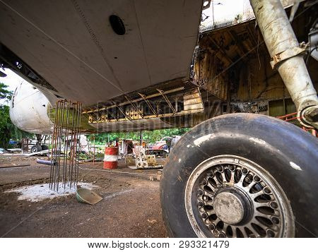 Aircraft Tires Under Repair On An Old Junkyard. Rusty And Broken Retractable Hydraulically Operated 