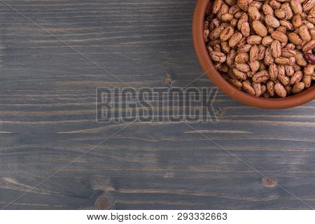 A Plate Of Beans On Wooden Table Background