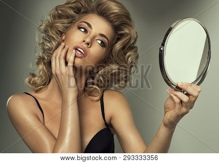 Attractive Sexy Blond Woman Admiring Her Beauty