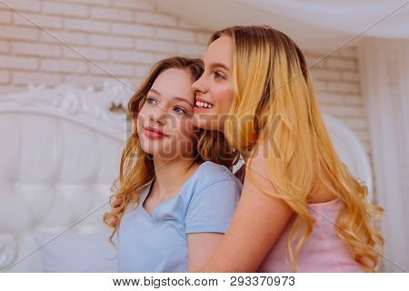 Appealing Teenage Girl Feeling Good Spending Time With Older Sister