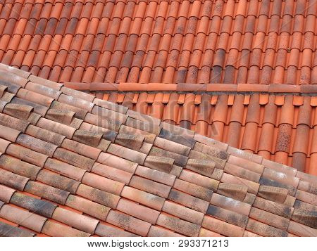 full frame image of orange terracotta tiled roofs with diagonal traditional pantiles in lines and rows