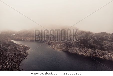 Lakes In Stone Rocky Mountains, Misty Foggy Day. Norway Summer Landscape. Norwegian National Tourist