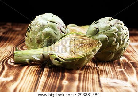 Artichokes On Rustic Background. Fresh Organic Artichoke Flower Set
