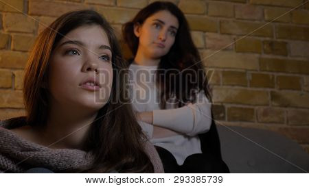 Closeup Shoot Of Two Young Cute Girls Watching Tv Together And Spending Time Together While Resting 