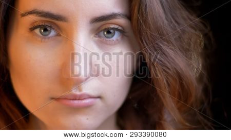 Closeup Shoot Of Young Pretty Caucasian Female With Brunette Curly Hair Looking Straight At Camera W