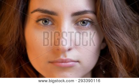 Closeup Shoot Of Young Pretty Caucasian Female With Brunette Curly Hair Looking Straight At Camera W