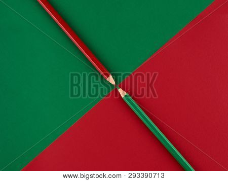 Red And Green Pencils On A Contrasting Background Of Red And Green Paper