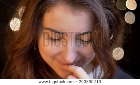 Closeup Shoot Of Young Attractive Caucasian Female Smiling Seductively And Biting Her Lip In Front O