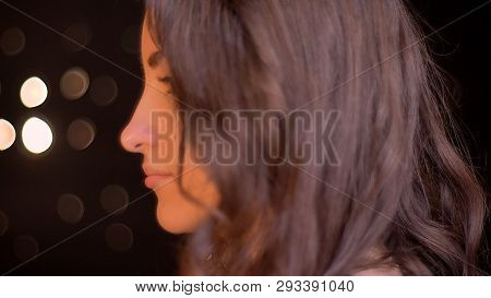Closeup Side View Shoot Of Young Attractive Caucasian Female Face Looking Forward With Bokeh Lights 