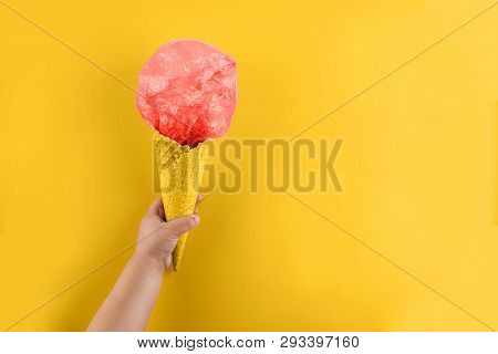 Childs Arm Holding Waffle Cone With Polyethylene Package In It. Ecology And Saving Earth Concept. Ou