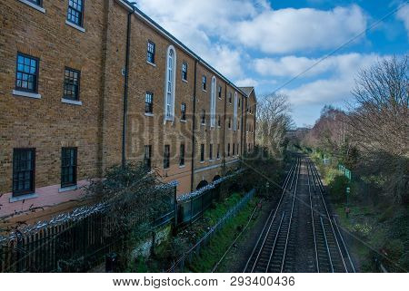 Railway Train With City Skyline In Background