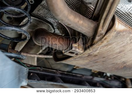 The Exhaust System In The Car Seen From Below, The Car Is On The Lift In The Car Workshop.
