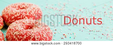 Donuts Decorated With Icing On Blue Background.