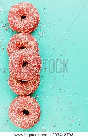 Donuts Decorated With Icing On Blue Background.