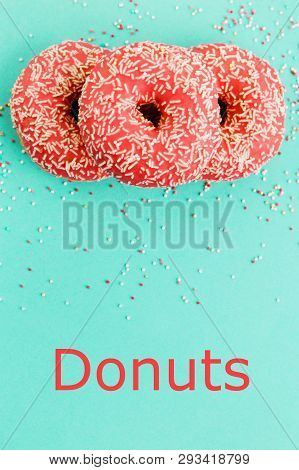 Donuts Decorated With Icing On Blue Background.