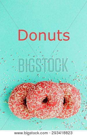 Donuts Decorated With Icing On Blue Background.