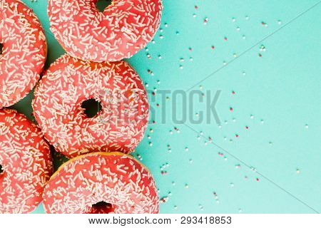 Donuts Decorated With Icing On Blue Background.