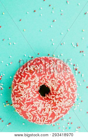 Donut Decorated With Icing On Blue Background.