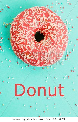Donut Decorated With Icing On Blue Background.