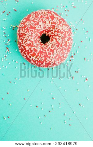 Donut Decorated With Icing On Blue Background.