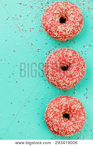 Donuts Decorated With Icing On Blue Background.
